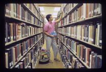 Student in Joyner Library stacks